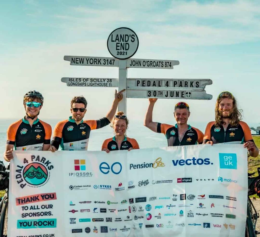 The pedal 4 parks team at land's end with the sponsorship banner.