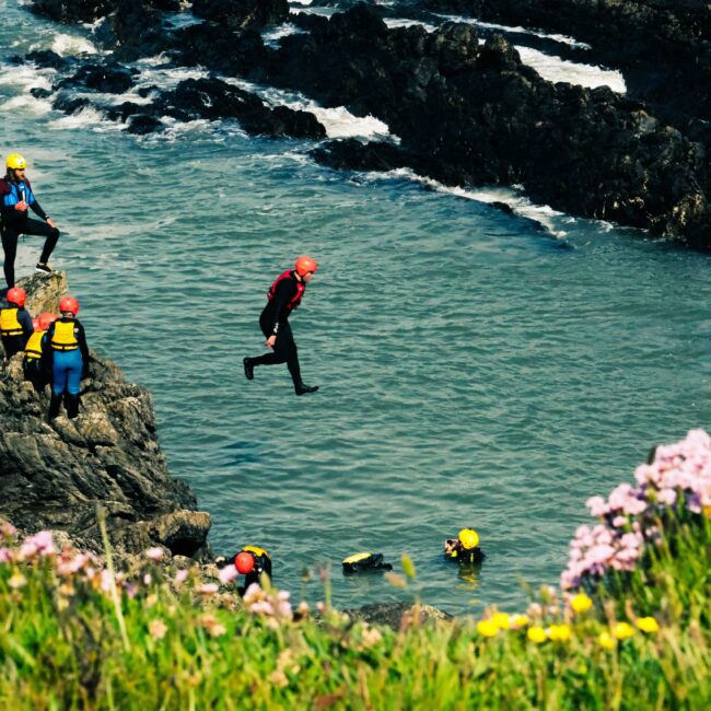 COASTEERING - 

Dive into the ocean, traverse rugged coastlines, and embrace the thrill of coasteering.